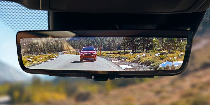 View of a Toyota Highlander Hybrid in a rear view mirror
