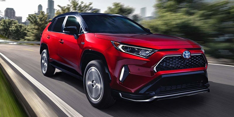 Front right view of a red Toyota RAV4 hybrid