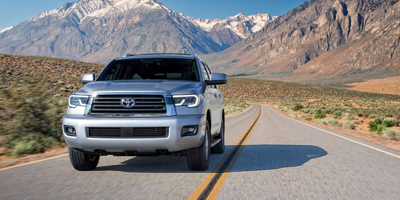 Front view of a silver 2021 Toyota Sequoia driving away from mountains